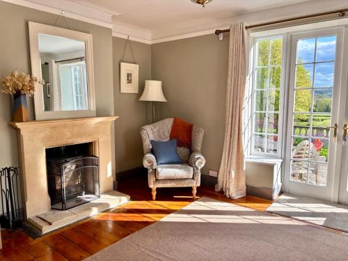 a living room with a chair and a fireplace at Humphreston House in Bristol