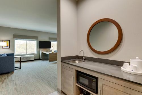 a hotel room with a sink and a mirror at Hampton Inn & Suites Weatherford, Tx in Weatherford