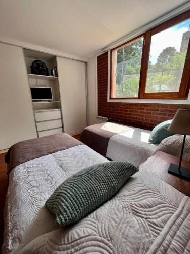a bedroom with two beds and a window at Casa Golf in Sierra de los Padres