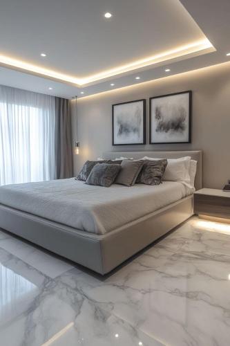 a bedroom with a large bed with marble floors at Paradise View Villas in Malindi