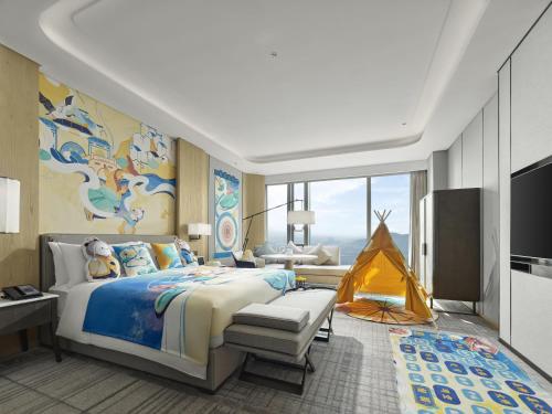 a bedroom with a large bed and a tent at Hilton Zhuji in Zhuji