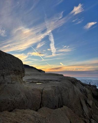 a view of a rocky beach with a cloudy sky at Dotties Retreat Qala in Qala