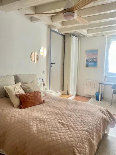 a bedroom with a large bed and a table at Good Vibes in Grenoble