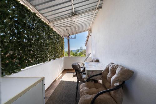 a balcony with two chairs and a table with a laptop at M Group Studios in Tivat