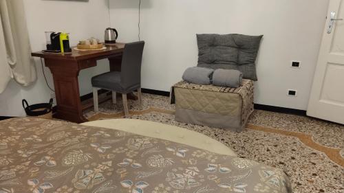 a bedroom with a bed and a desk and a chair at Contessa Alba in Savona