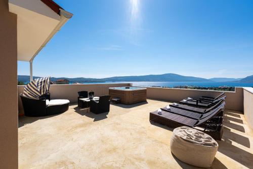 a balcony with furniture and a view of the ocean at Adriatic Nest Residence in Tivat