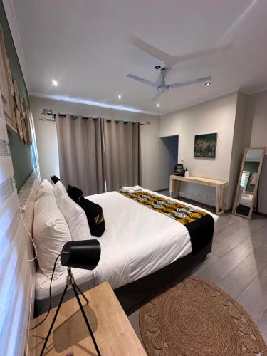a bedroom with a large bed in a room at Imbarudo Residence in Victoria Falls
