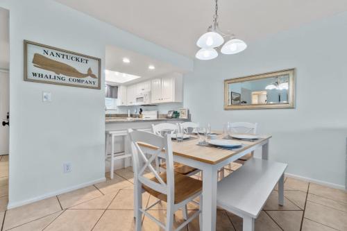 a kitchen and dining room with a table and chairs at Sand Between Stays in Orange Beach
