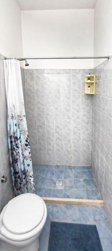 a bathroom with a toilet and a shower curtain at Cala Dei Saraceni in Peschici