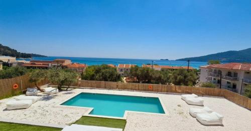 a swimming pool with a view of the ocean at Pnoé Sea View Suites in Limenas