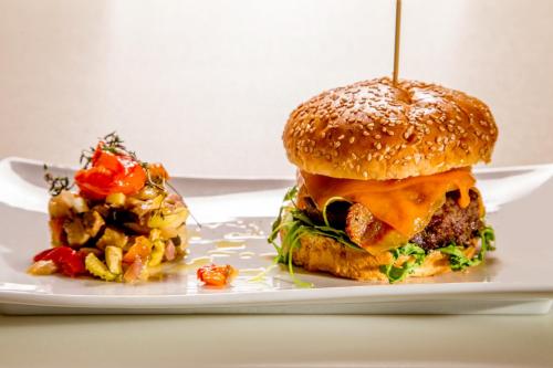a sandwich and a salad on a white plate at Hotel Mozart in Rome