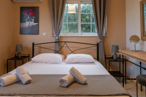 a bedroom with a bed with two pillows on it at Monte Mare Rhodes in Ixia