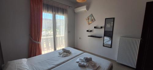 a bedroom with a bed and a window at Rhodian Villa in Kremasti