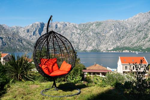 a swing chair sitting on top of a hill at Horizon Apartments in Prčanj