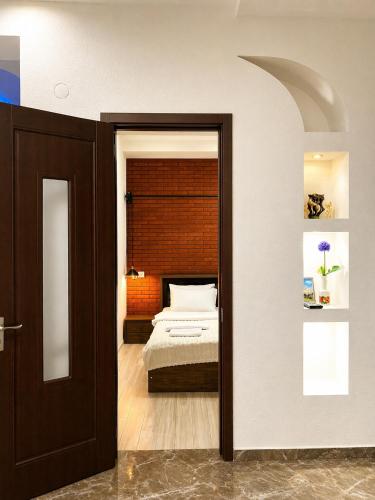 a bedroom with a bed in a room with a mirror at Vernisa Hotel in Tbilisi City
