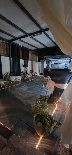 a room with a piano and chairs and a plant at Villa Glamour in Utjeha