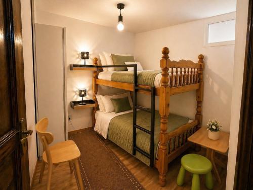 a bedroom with two bunk beds and a table at Chez Fifi in Surpierre