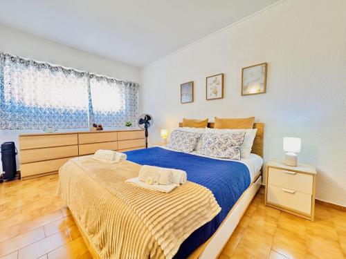 a bedroom with a large bed with blue sheets at Sol e Piscina na Caparica - By Caparica Villas in Costa da Caparica