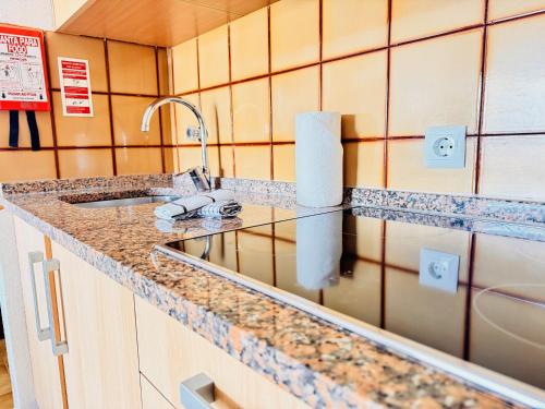 a kitchen with a sink and a counter top at Sol e Piscina na Caparica - By Caparica Villas in Costa da Caparica