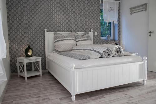 a white bed in a bedroom with a window at Ferienwohnung Viva la Vida in Bendorf
