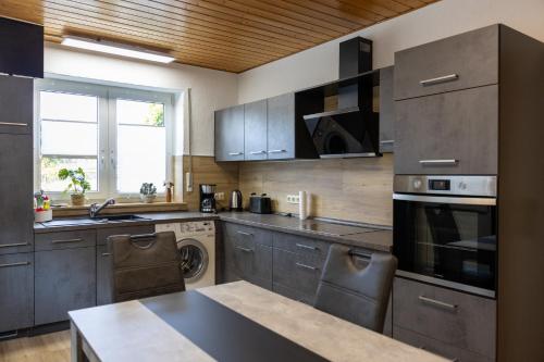 a kitchen with stainless steel cabinets and a sink at Auszeit im Sauerland in Meschede