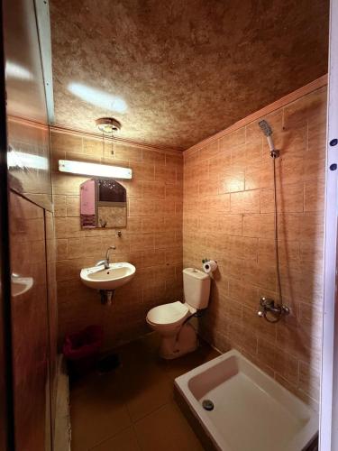 a bathroom with a toilet and a sink and a shower at Fouad Hotel in Alexandria