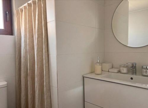 a white bathroom with a sink and a mirror at Increible Chalet en La Parva in Santiago