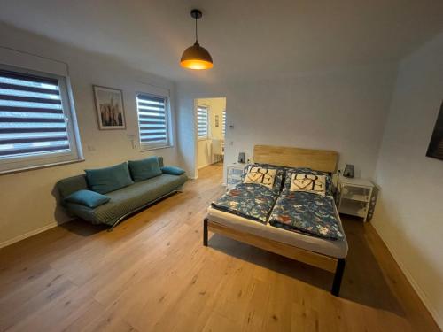 a living room with a bed and a couch at Apartment Mirabelle 4 in Püttlingen