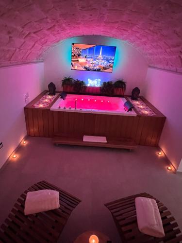 a jacuzzi tub in a room with purple lighting at Buonaventura house in Triggiano