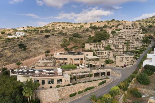 a village on a hill with houses on a road at Domes Aulus Elounda, Adults only, Curio Collection by Hilton in Elounda