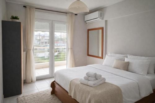 a bedroom with a bed with two towels on it at Epanomi Family Apartments in Epanomi