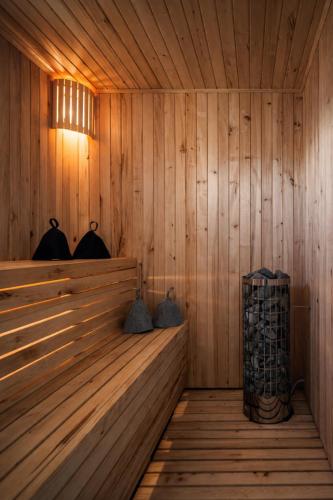 a sauna with wooden walls and a wooden floor at Palanga Waterhouse in Kiauleikiai