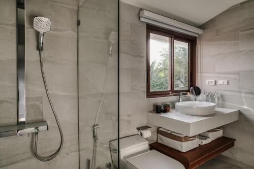 a bathroom with a sink and a shower at Sontaya - Lakeside Studio Villa in Ban Khao Thong