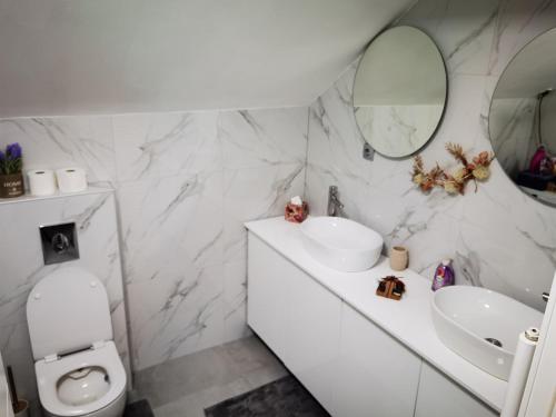 a bathroom with a toilet and a sink and a mirror at Danin's Home in Tuzla
