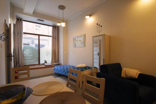 a living room with a couch and a table at Izba Kupiecka in Bystrzyca Kłodzka