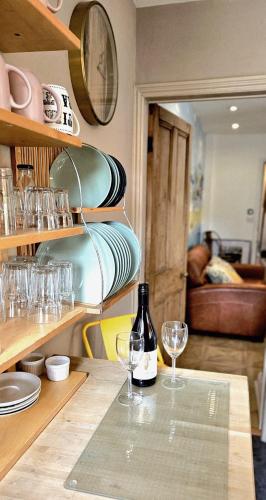 a table with glasses and a bottle of wine at The Beaches - En-suite Rooms in Redcar