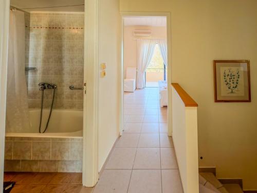 a bathroom with a shower and a tub at Seliandros Aura Villa in Dhiminión
