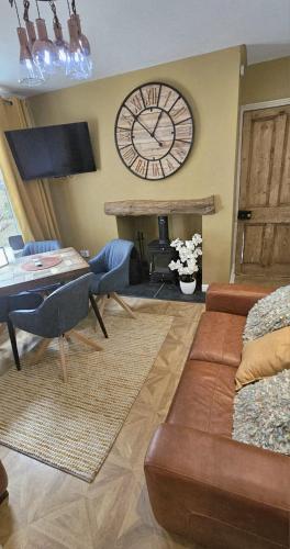 a living room with a large clock on the wall at The Beaches - En-suite Rooms in Redcar