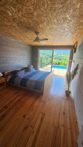 a bedroom with a bed and a large window at Sole d'Oro in San-Nicolao