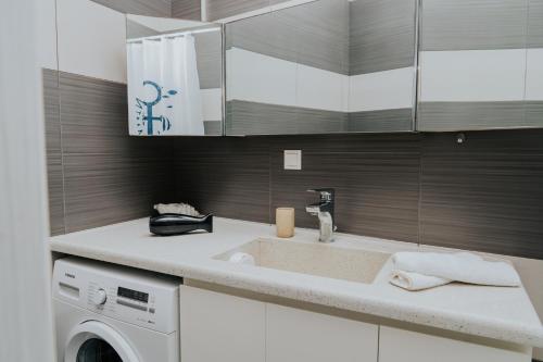 a kitchen with a sink and a washing machine at Seaside suite in Crete in Kokkini Khanion