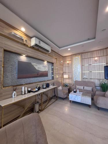 a living room with a large flat screen tv on the wall at فندق الميار , Al Mayar Hotel in Medina