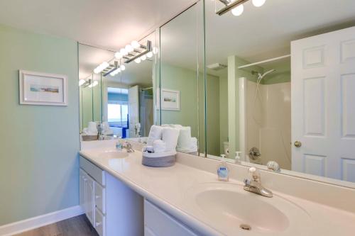 a bathroom with two sinks and a large mirror at ‘Emerald Dreams’ Beach & Lakefront West PCB Condo in Panama City Beach