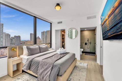 a bedroom with a bed and a large window at Beautiful Miami Apt Pool & Beach for 3 Guests in Miami