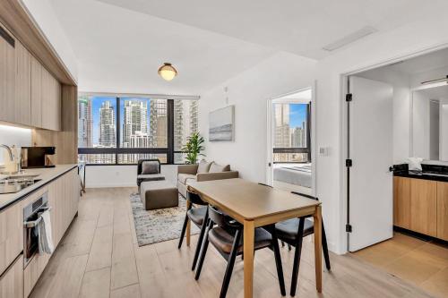 a kitchen with a table and a living room at Beautiful Miami Apt Pool & Beach for 3 Guests in Miami