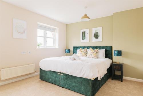a bedroom with a large bed with white sheets at 4 Bedroom House in Shrewsbury in Shrewsbury