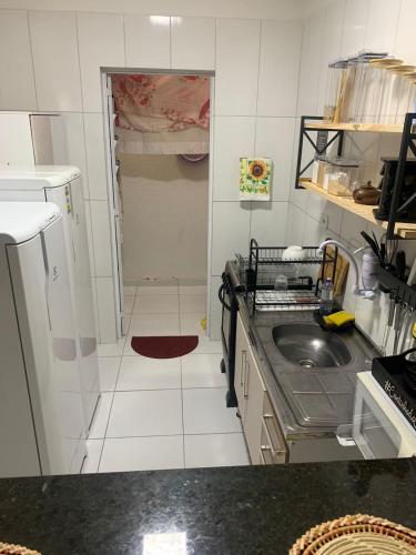a small kitchen with a sink and a stove at Praia do Frances-Riviera do Frances casa 37 in Marechal Deodoro