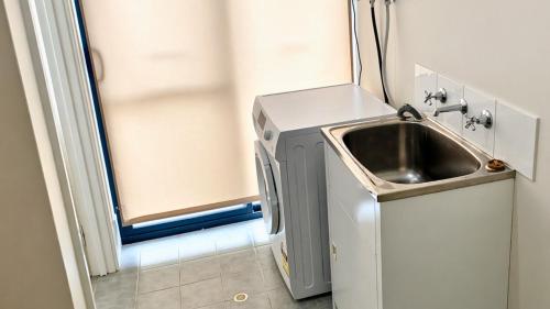 a small kitchen with a sink and a refrigerator at Wagon Holiday Home in Broadwater