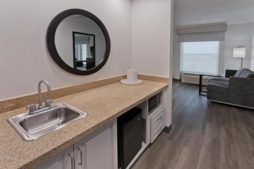 a kitchen and living room with a sink and a mirror at Hampton Inn & Suites Lanett/West Point in Lanett