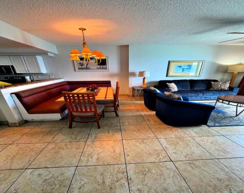 a living room with a couch and a table at Wyndham Ocean Walk 2 BR Resort Condo Direct Oceanfront - Daytona Funland 22260 in Daytona Beach