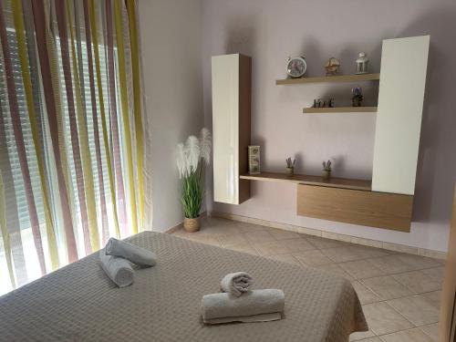 a bedroom with a bed with a towel on it at Eri's House in Chrysoupolis
